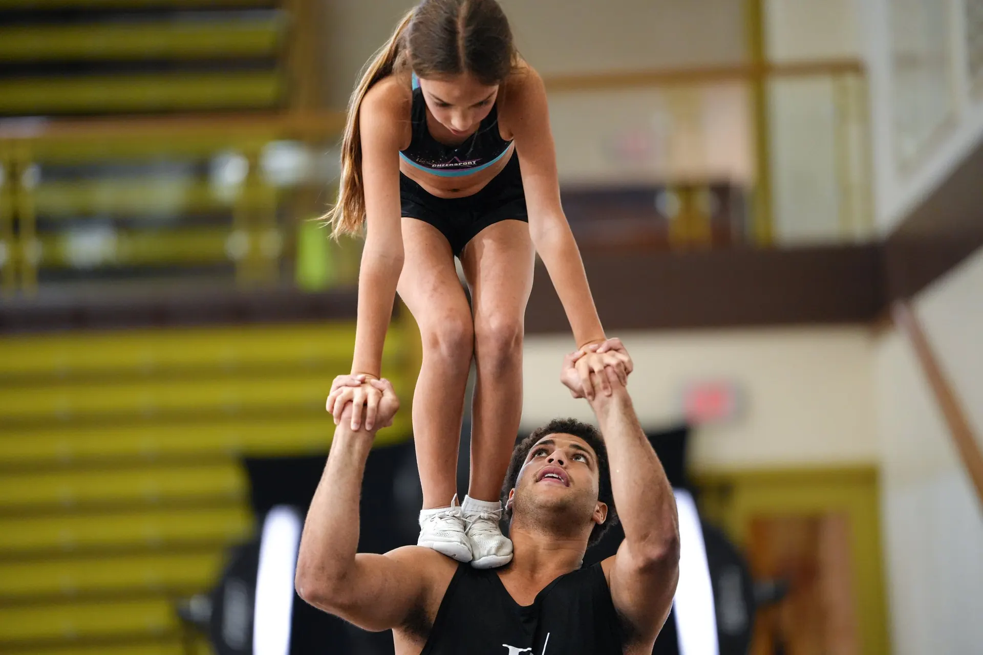 A coach spotting a flyer in a stunt